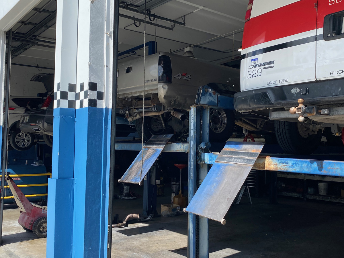 Vehicles on lifts in a service garage.